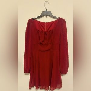 Beautiful sleeved netted red dress.